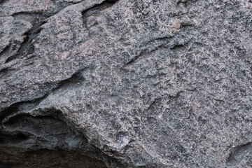 Rough surface of a old granite boulder. Abstract pattern of raw granite. Stone texture for background use. 