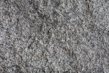 Rough surface of a old granite boulder. Abstract pattern of raw granite. Stone texture. 