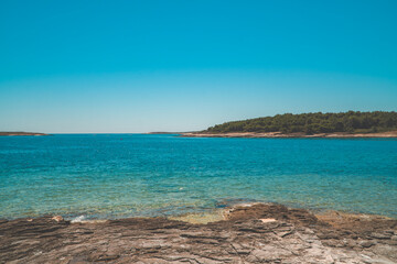 Stony rock beach with beautiful turquoise waters in Kamenjak, Istria, Croatia