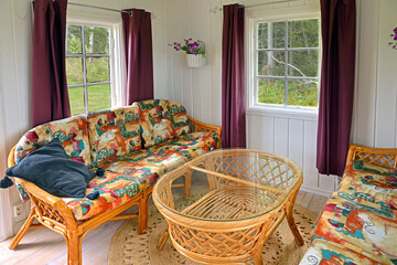 Wicker furniture in small cottage in forest. Aland Islands