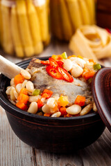 Stewed vegetables with beans and beef bone in pot