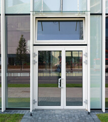 Fototapeta na wymiar New glass windows and door of a modern emty city office building