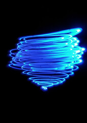 Light painting design. Combination of sky blue and white light against a black background 