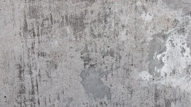 Texture background of old gray concrete wall with spots, smudges, traces of paint, scratches and roughness. dolly camera movement