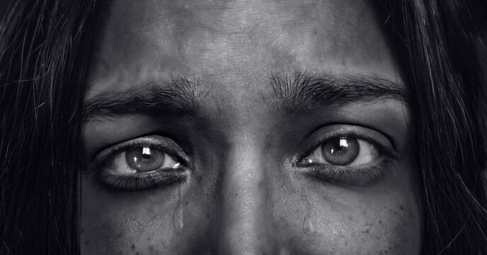 young woman with sad eyes - crying girl in depression - emotional pain