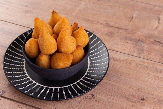 traditional Brazilian fried snack made with chicken known as "coxinha"