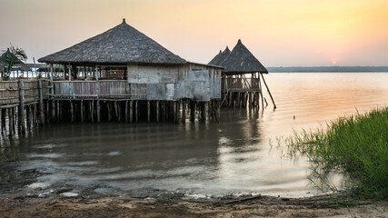 Sunset with stilt house on Aheme lake