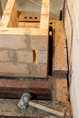 Sauna stove that is being built from fire resistant material in undeveloped interior laid out of foam blocks in country house under construction
