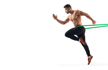Shirtless bodybuilder running using resistance band.