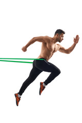 Shirtless bodybuilder running using resistance band.