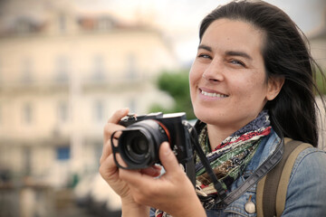 Portrait of woman reporter taking pictures with reflex camera