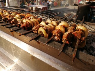 Shashlik preparing on a barbecue grill over charcoal. Shashlik or Shish kebab popular in Eastern Europe.
