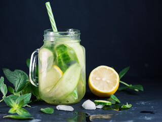 Close-up detox water with cucumber, mint and lemon in a jar . Summer cold healthy drink