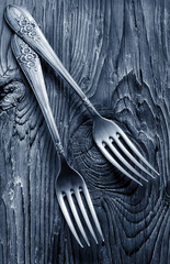 vintage silver forks on aged wood
