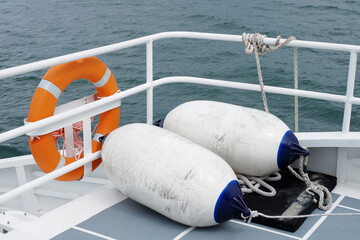 Lifebuoy hanging on a Iron railings of the boat With a security concept , Ideal for use in the...