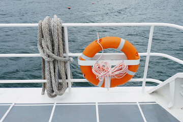 Lifebuoy hanging on a Iron railings of the boat With a security concept , Ideal for use in the...