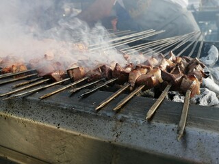 Shashlik preparing on a barbecue grill over charcoal. Shashlik or Shish kebab popular in Eastern Europe.