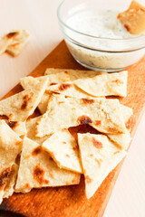Homemade sesame pita chips with sauce