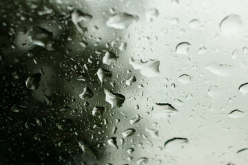 Rain drops on a windscreen with out of focus elements