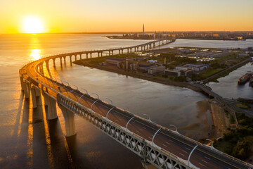 Obraz premium High-speed toll road, highway bypassing the city center St. Petersburg, the central section of the western high-speed section. A beautiful view of the sunset over the Gulf of Finland