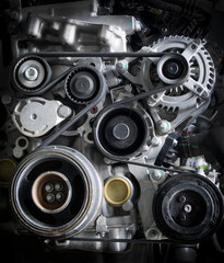 Diesel car engine with pulley and belt on dark tone background