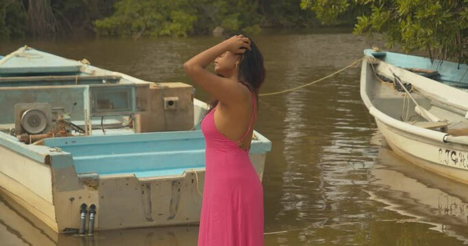 Epic videoshoot in a lagoon with fishing boats in the background of this east indian Caribbean model