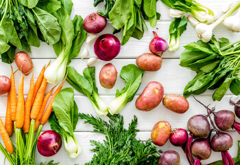 Carrot, potato, beet, onion and spinach on white background top view
