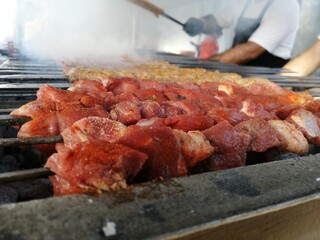 Shashlik preparing on a barbecue grill over charcoal. Shashlik or Shish kebab popular in Eastern Europe.