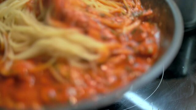 4K dish of pasta cooked to tradition with fresh Italian tomato, tuna, close-up