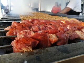 Shashlik preparing on a barbecue grill over charcoal. Shashlik or Shish kebab popular in Eastern Europe.