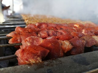 Shashlik preparing on a barbecue grill over charcoal. Shashlik or Shish kebab popular in Eastern Europe.