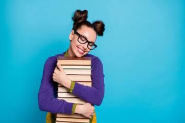 Portrait of her she nice attractive pretty charming dreamy sweet cheerful girl embracing pile book isolated on bright vivid shine vibrant blue green teal turquoise color background