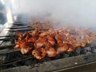 Shashlik preparing on a barbecue grill over charcoal. Shashlik or Shish kebab popular in Eastern Europe.