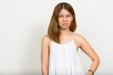 Portrait of young Asian woman against white background