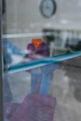 Selective focus of cleaner using squeegee handle and detergent on window