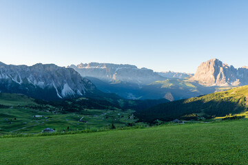 Summer morning view of Seceda Odle Puez mountain and wooden chalets in Dolomites, Trentino Alto Adige, South Tyrol, Italy