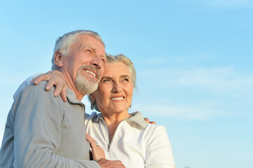 Close-up portrait of happy senior couple hugging