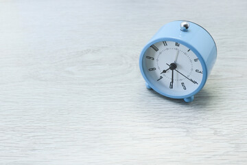 Alarm clock on a wooden background