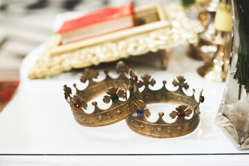Golden crowns lying on the table in church