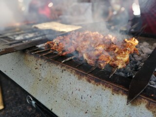 Shashlik preparing on a barbecue grill over charcoal. Shashlik or Shish kebab popular in Eastern Europe.