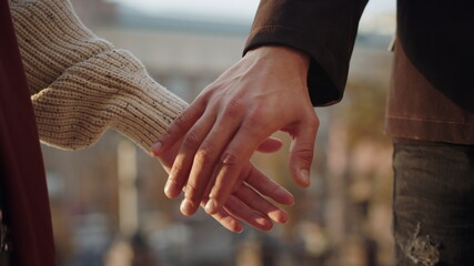Closeup couple meeting hands outdoors. Love couple holding hands