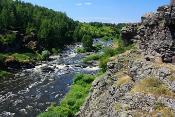 Large boulders lie in a mountain river