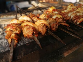 Shashlik preparing on a barbecue grill over charcoal. Shashlik or Shish kebab popular in Eastern Europe.