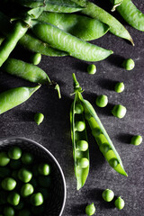 Fresh homegrown green peas in moody dark photography