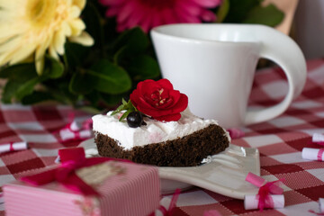 Delicious homemade birthday cake with cup of coffee for mum's birthday with present and flowers