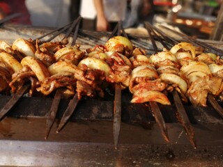 Shashlik preparing on a barbecue grill over charcoal. Shashlik or Shish kebab popular in Eastern Europe.