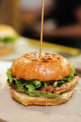 Burgers with lettuce, cutlet and tomatoes. Burgers in the restaurant. Burgers close up. Fast food, wrong food. Fat. Obesity