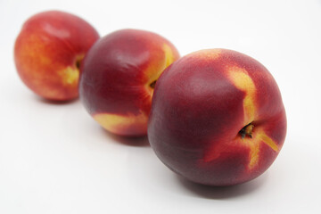 Three nectarines on white background. Nectarine fruit isolated on white background	