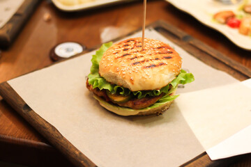 Burgers with lettuce, cutlet and tomatoes. Burgers in the restaurant. Burgers close up. Fast food, wrong food. Fat. Obesity
