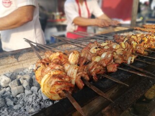 Shashlik preparing on a barbecue grill over charcoal. Shashlik or Shish kebab popular in Eastern Europe.